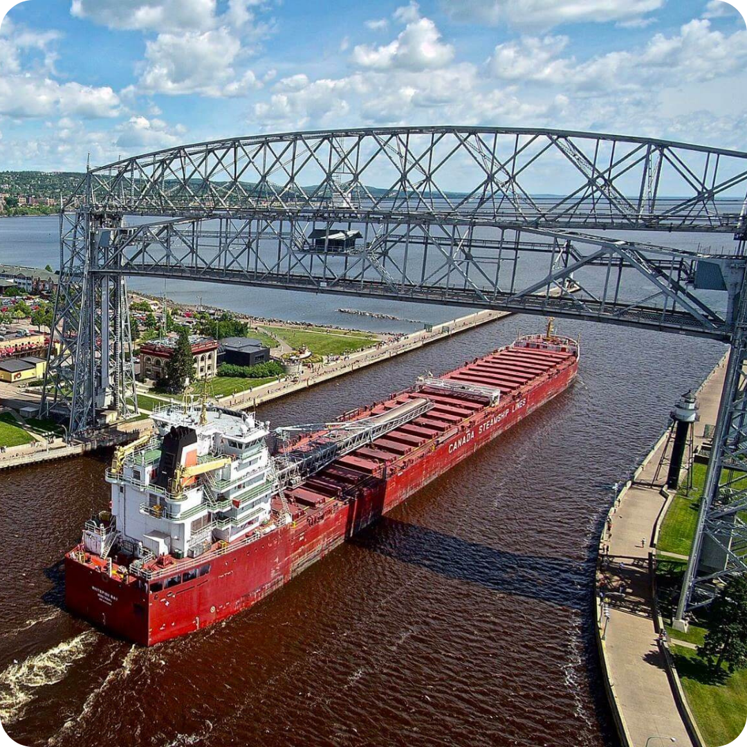 Photo from above of the Aerial lift bridge in duluth mn with a great lakes freighter going under it